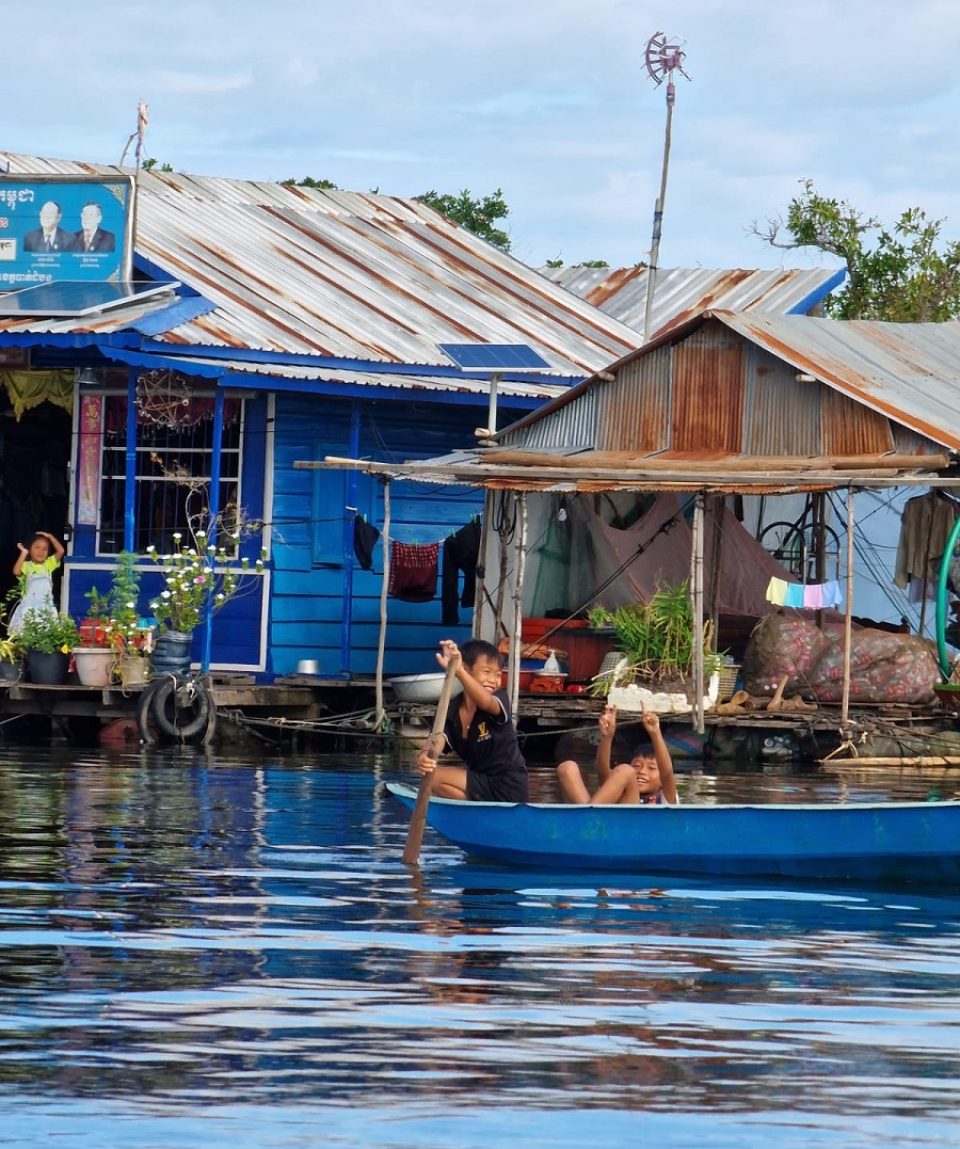 Kids enjoy their boat through their floating village
